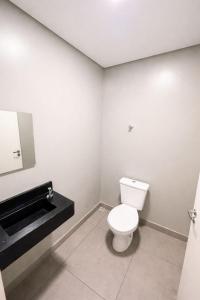 a bathroom with a white toilet and a sink at sleep airport congonhas in São Paulo