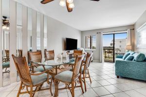 a dining room with a table and chairs at Condo by the beach with Gulf views plus shared pool in Fort Morgan