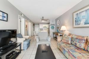 a living room with a couch and a fireplace at Plantation East #2314 in Gulf Shores