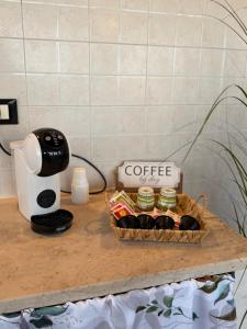 a basket of coffee on a table next to a coffee maker at SvEly House B&B in Campomarino