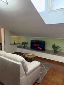 a living room with a couch and a tv at SvEly House B&B in Campomarino