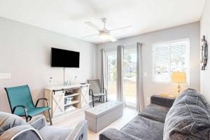 a living room with a couch and a tv at Plantation East #4113 in Fort Morgan