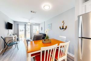 a kitchen and dining room with a table and a refrigerator at Plantation East #4113 in Fort Morgan