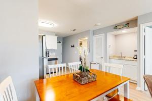 a kitchen and dining room with a wooden table at Plantation East #4113 in Fort Morgan