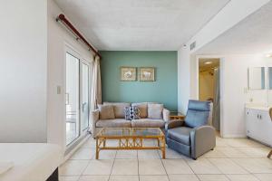 a living room with a couch and a table at Contemporary beachside escape with gym & pools in Fort Morgan