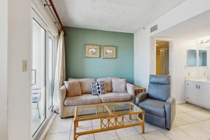 a living room with a couch and a chair at Contemporary beachside escape with gym & pools in Fort Morgan