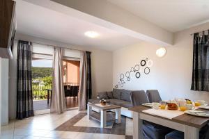 a living room with a couch and a table at Apartments Mistral in Lopar