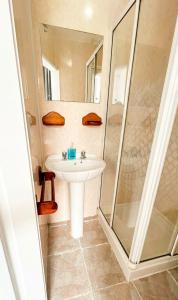 a bathroom with a sink and a shower at Mayfair hotel Blackpool city centre in Blackpool
