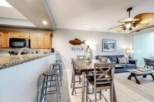 a kitchen and living room with a table and chairs at The Indies #503 in Fort Morgan