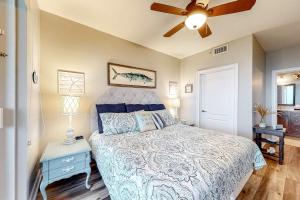 a bedroom with a bed and a ceiling fan at The Indies #503 in Fort Morgan +26 photos