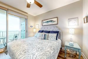 a bedroom with a bed and a balcony at The Indies #503 in Fort Morgan