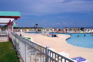 a large swimming pool with people in the water at Gulf view duplex with multi-level balcony hot tub in Fort Morgan