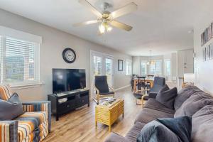 a living room with a couch and a flat screen tv at Gulf view duplex with multi-level balcony hot tub in Fort Morgan