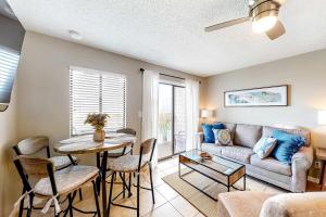 a living room with a couch and a table at Plantation East 2205 in Gulf Shores