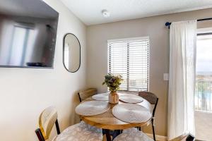 a dining room with a table and chairs and a window at Plantation East 2205 in Gulf Shores