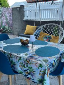 a table with a colorful table cloth on a patio at Ti kaz a fredo in Port-Louis