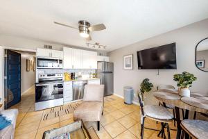 a kitchen with a table and a dining room at Plantation East 2205 in Gulf Shores