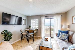 a living room with a couch and a table at Plantation East 2205 in Gulf Shores