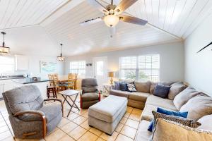 a living room with a couch and chairs and a kitchen at Blue Marlin in Gulf Shores