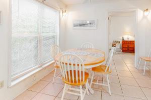 a dining room with a table and chairs at Campbellot by Meyer Vacation Rentals in Fort Morgan