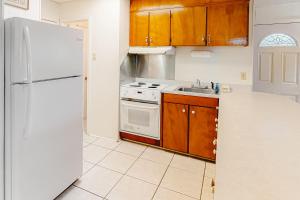 a kitchen with a white refrigerator and a sink at Campbellot by Meyer Vacation Rentals in Fort Morgan