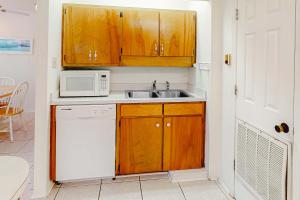 a kitchen with a sink and a microwave at Campbellot by Meyer Vacation Rentals in Fort Morgan