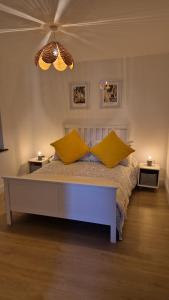 a bedroom with a bed with two yellow pillows on it at Muckish Hideaway in Crockglass +15 photos