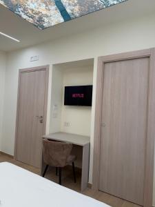 an office with a desk and a sign on the wall at Ludogà Luxury Suite in Trebisacce