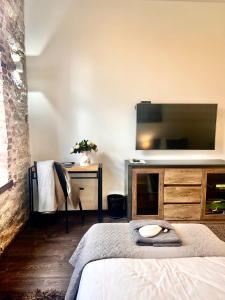 ein Schlafzimmer mit einem Bett und einem Fernseher an der Wand in der Unterkunft Vabriku 6 Apartment with sauna in Rakvere