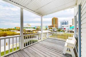 a porch with a chair and a view of the water at Beach Haven by Meyer Vacation Rentals in Gulf Shores