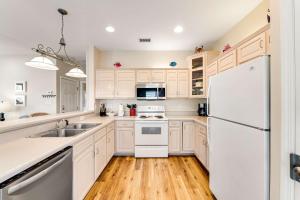 a kitchen with white appliances and a white refrigerator at Beach Haven by Meyer Vacation Rentals in Gulf Shores +31 photos