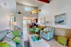 a living room with a couch and a table at Beautiful condo with shared pools full kitchen private washer dryer in Gulf Shores