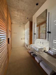 a bathroom with two sinks and a large mirror at El Guayacan in Zipolite +38 photos
