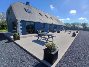 a building with a picnic table in front of it at The Coast House in Kilmore