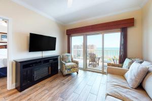 a living room with a flat screen tv and a couch at Crystal Tower 705 in Gulf Shores