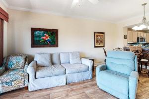 a living room with a couch and a chair at Crystal Tower 705 in Gulf Shores