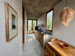 a kitchen with a wooden counter and some windows at El Guayacan in Zipolite