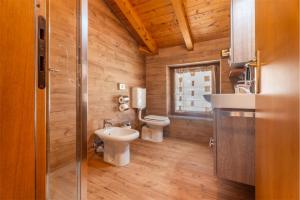 a bathroom with two toilets and a sink at CROSINA HOLIDAY - Casa Al Ponte in Ledro +97 photos