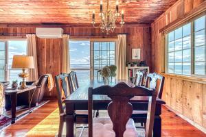 a dining room with a table and a view of the ocean at 2BR Beachfront Cottage w/ Grill & Expansive Deck in Point Roberts