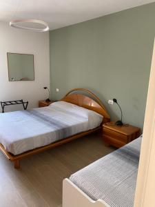 a bedroom with two beds and a lamp on a table at Villa swimming pool Ca'Du'Ma' Portofino view ovest in Lavagna