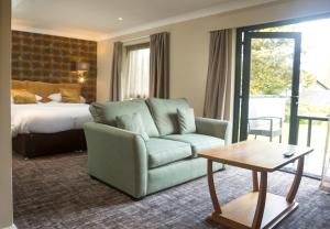 a living room with a couch and a bed at The Waterloo Hotel in Betws-y-coed +57 photos