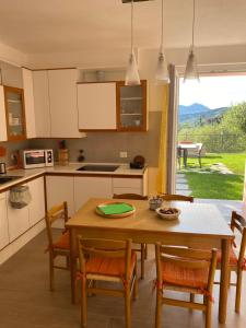 a kitchen with a wooden table and chairs and a table at Villa swimming pool Ca'Du'Ma' Portofino view ovest in Lavagna