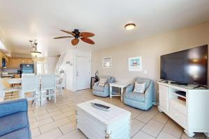 a living room with a large flat screen tv at Sweet Alabama in Gulf Shores
