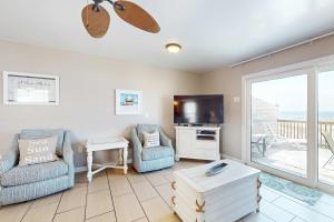 a living room with two chairs and a flat screen tv at Sweet Alabama in Gulf Shores