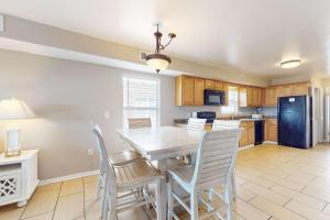 a kitchen and dining room with a table and chairs at Sweet Alabama in Gulf Shores