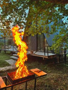 a piece of fire in front of a cabin at Rachuli blendi in Ambrolauri