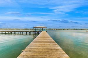 a wooden pier with a gazebo on the water at Sea Oats E106 in Gulf Shores