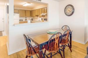 a kitchen and dining room with a table and chairs at Sea Oats E106 in Gulf Shores