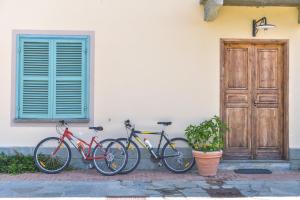three bikes parked next to a building with a door at Relax Cascina Lissona in Sessant