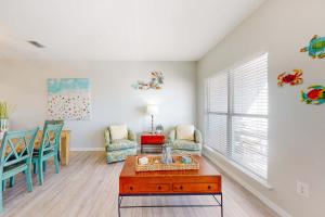 a living room with a table and chairs at Sun & Sea in Gulf Shores